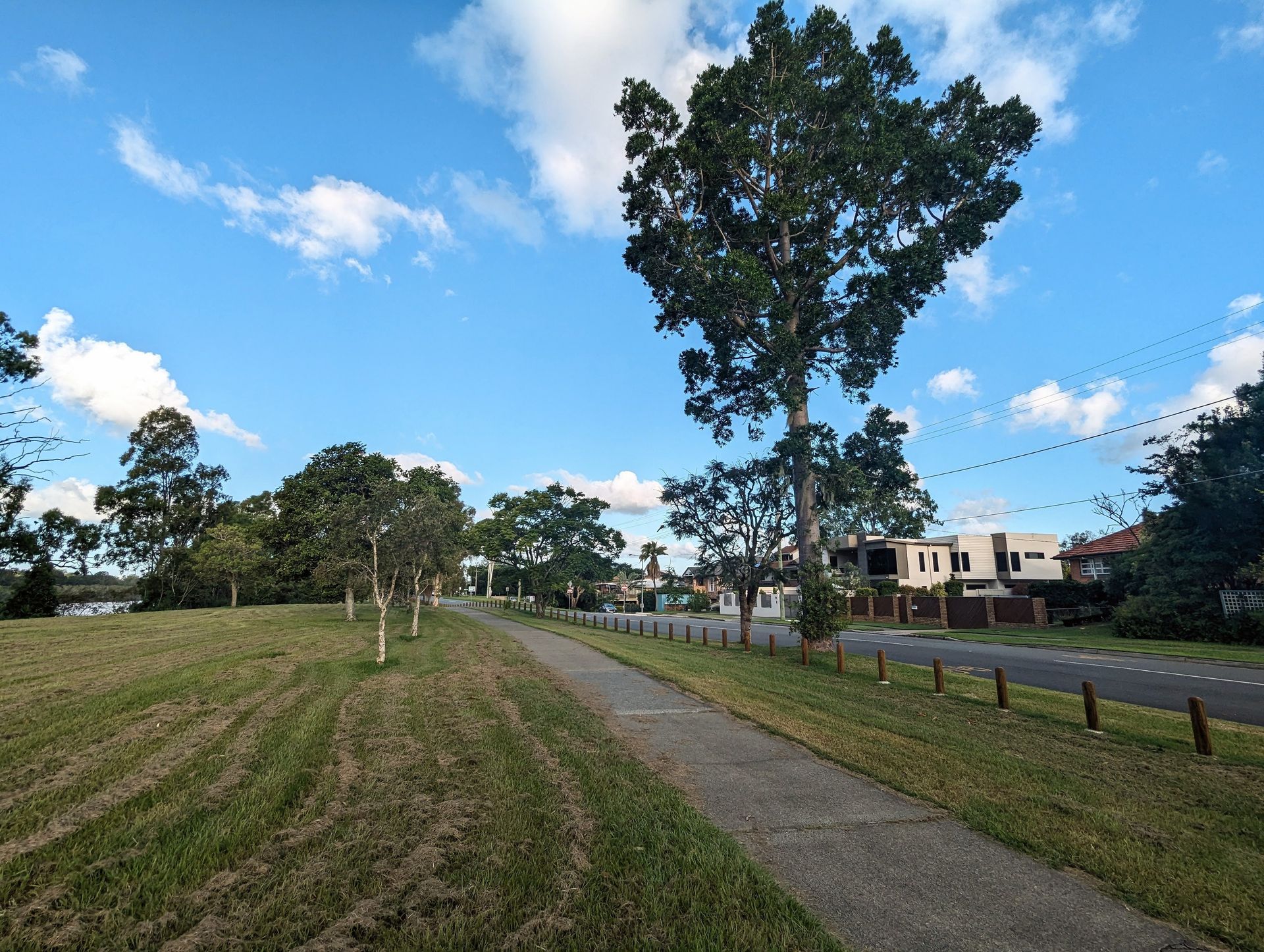 A narrow off-road bikeway runs alongside the Brisbane Corso and river