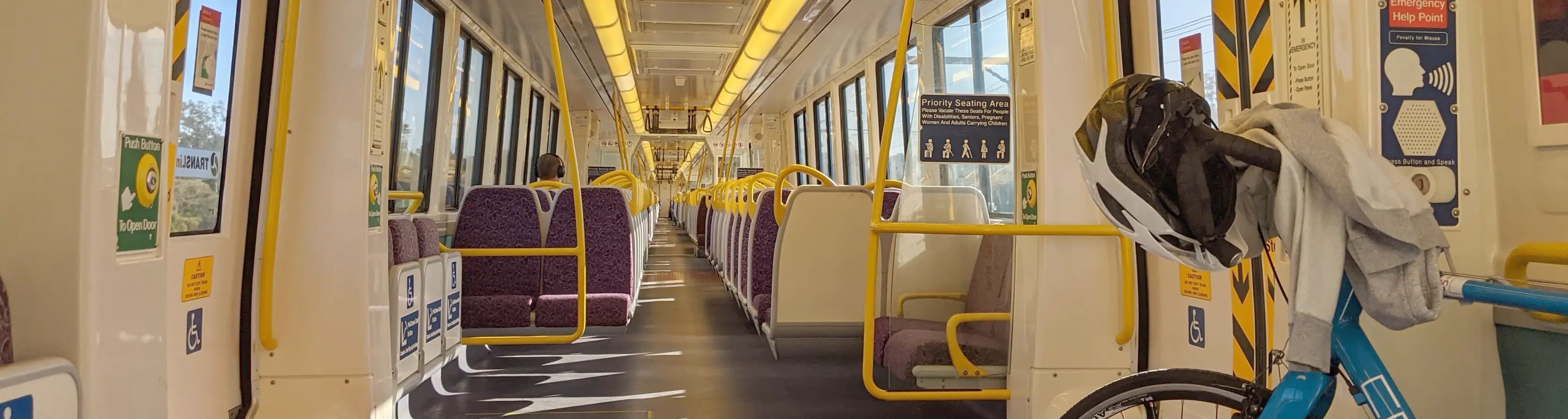 A blue bike in a mostly empty train carriage