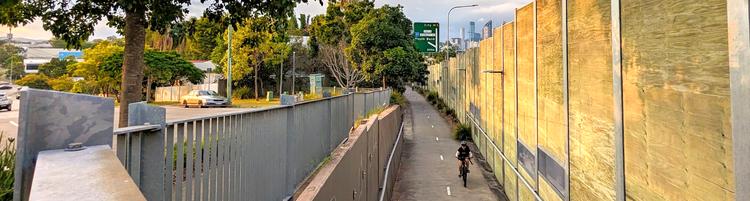 The bikeway is a prominent piece of infrastructure, stretching off towards Brisbane City in the distance.